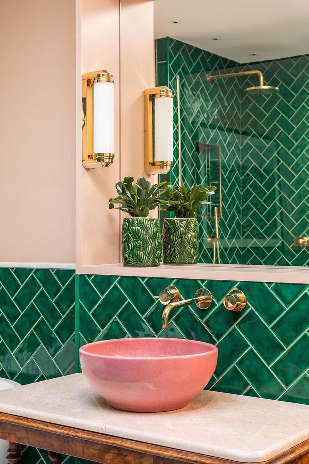 Contemporary bathroom featuring vibrant green tiles and pink basin sink