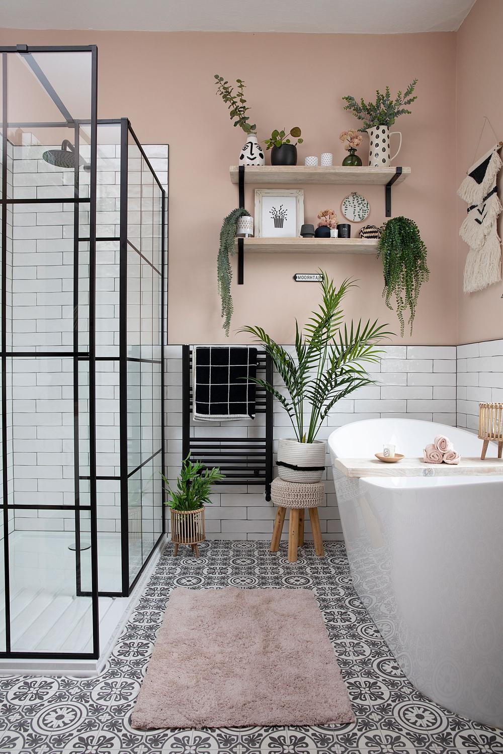 A modern pink-themed bathroom featuring elegant fixtures and a serene bathtub.