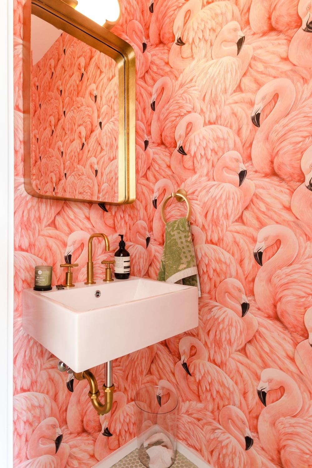 Vibrant pink bathroom featuring flamingo patterned wallpaper and modern fixtures