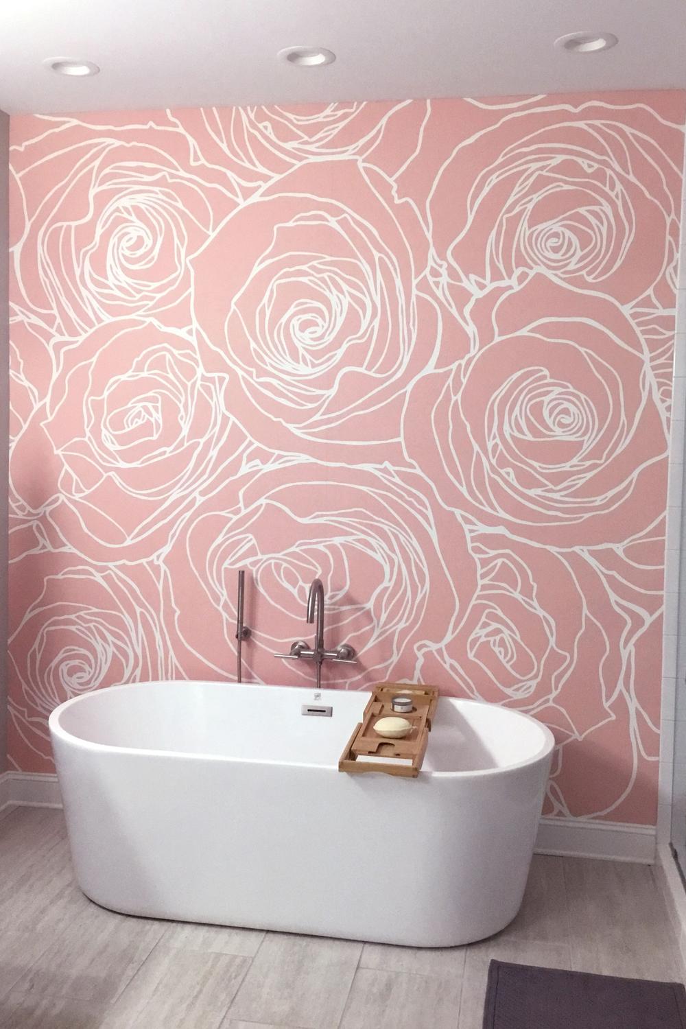 Stylish bathroom featuring pink wallpaper with white rose patterns