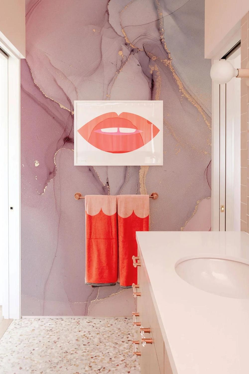 Stylish bathroom with marbled pink and purple wallpaper and elegant features
