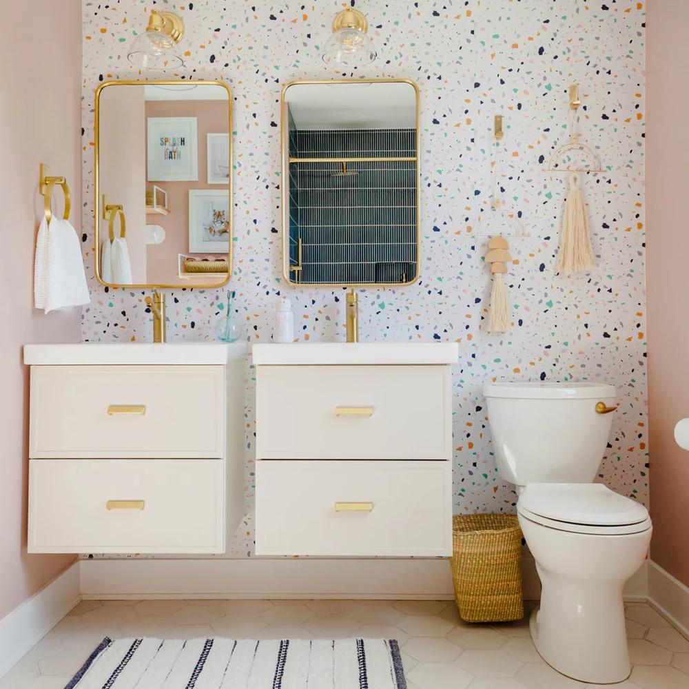 Contemporary pink bathroom featuring playful speckled wallpaper