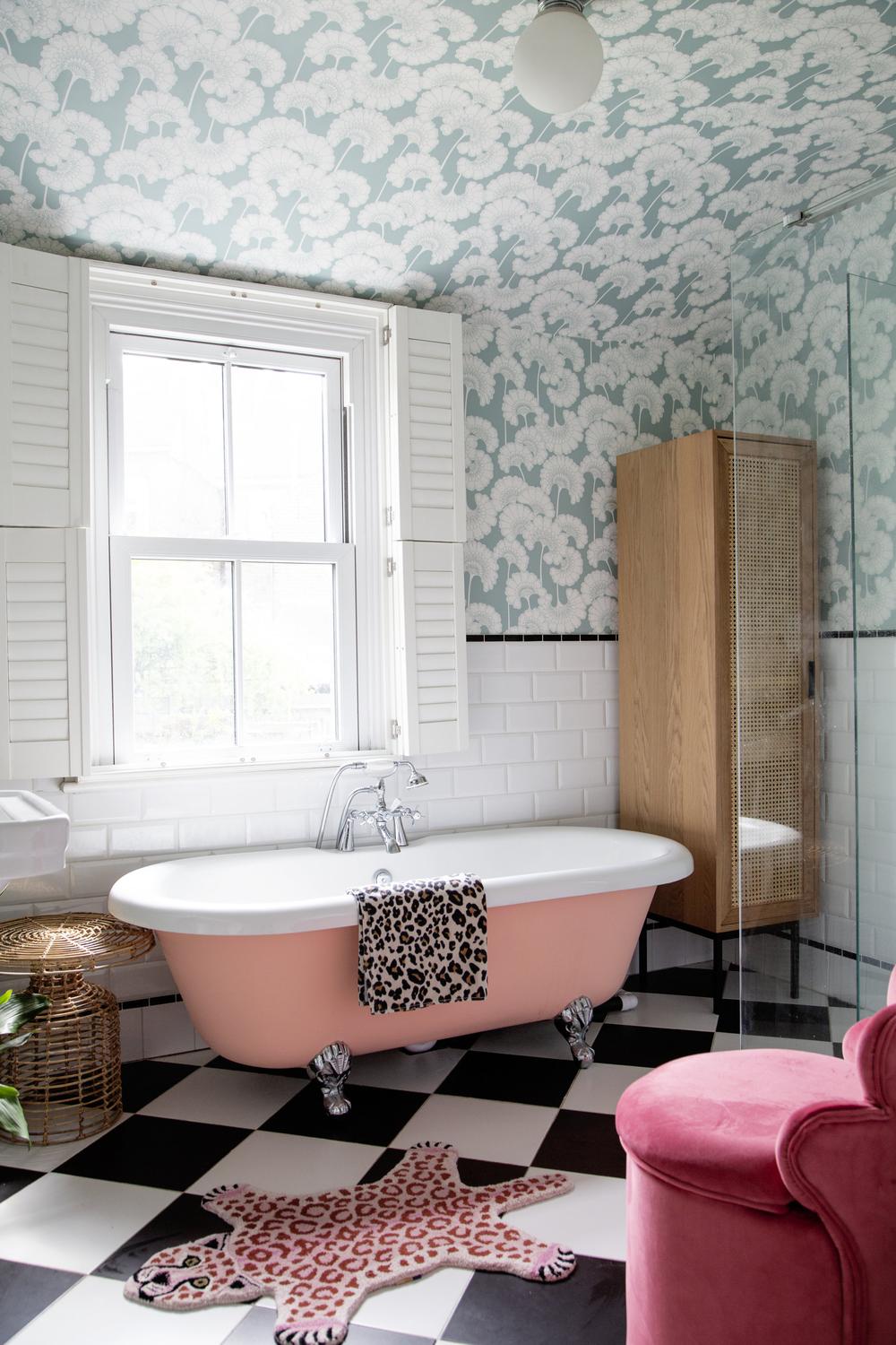 Stylish bathroom with floral wallpaper and chic bathtub