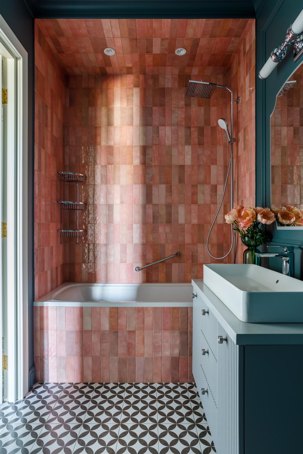 Modern pink rustic bathroom with textured tiles and stylish fixtures.