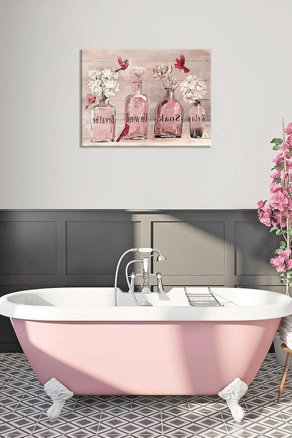 Freestanding pink bathtub and elegant decor in a rustic bathroom.