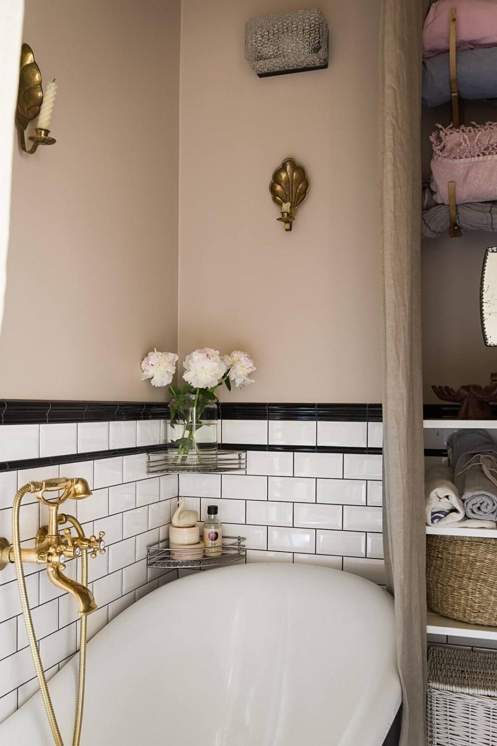 Rustic pink bathroom featuring geometric tile designs and vintage decor.