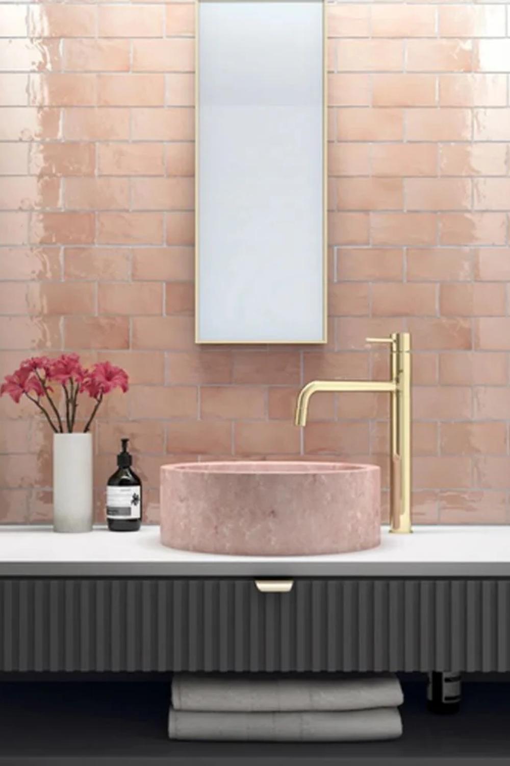 Charming rustic bathroom featuring pink hues and textured design elements.