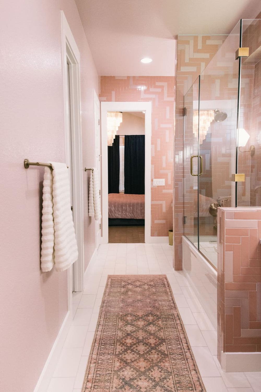 Baño vintage con azulejos rosas que transmiten un aire retro encantador.