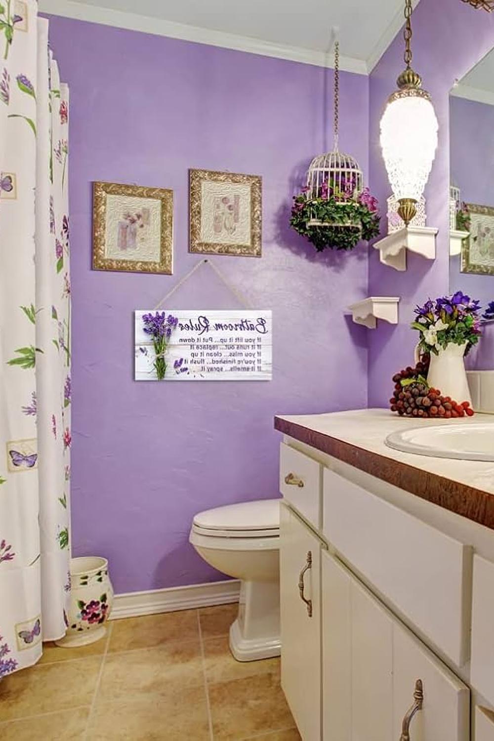 A charming, pastel purple bathroom with floral patterns and elegant decor.