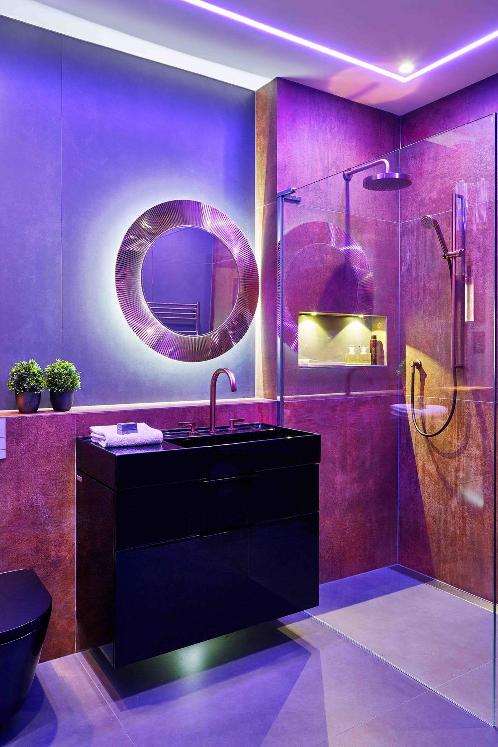 Contemporary bathroom featuring vibrant purple accents and structured design.