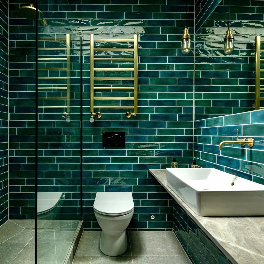 Bathroom designed with teal and purple accents focusing on sleek, modern features.