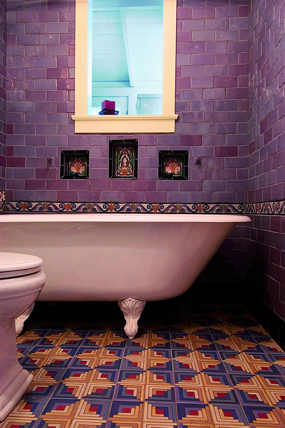 Bathroom with deep purple tiles and vintage bathtub