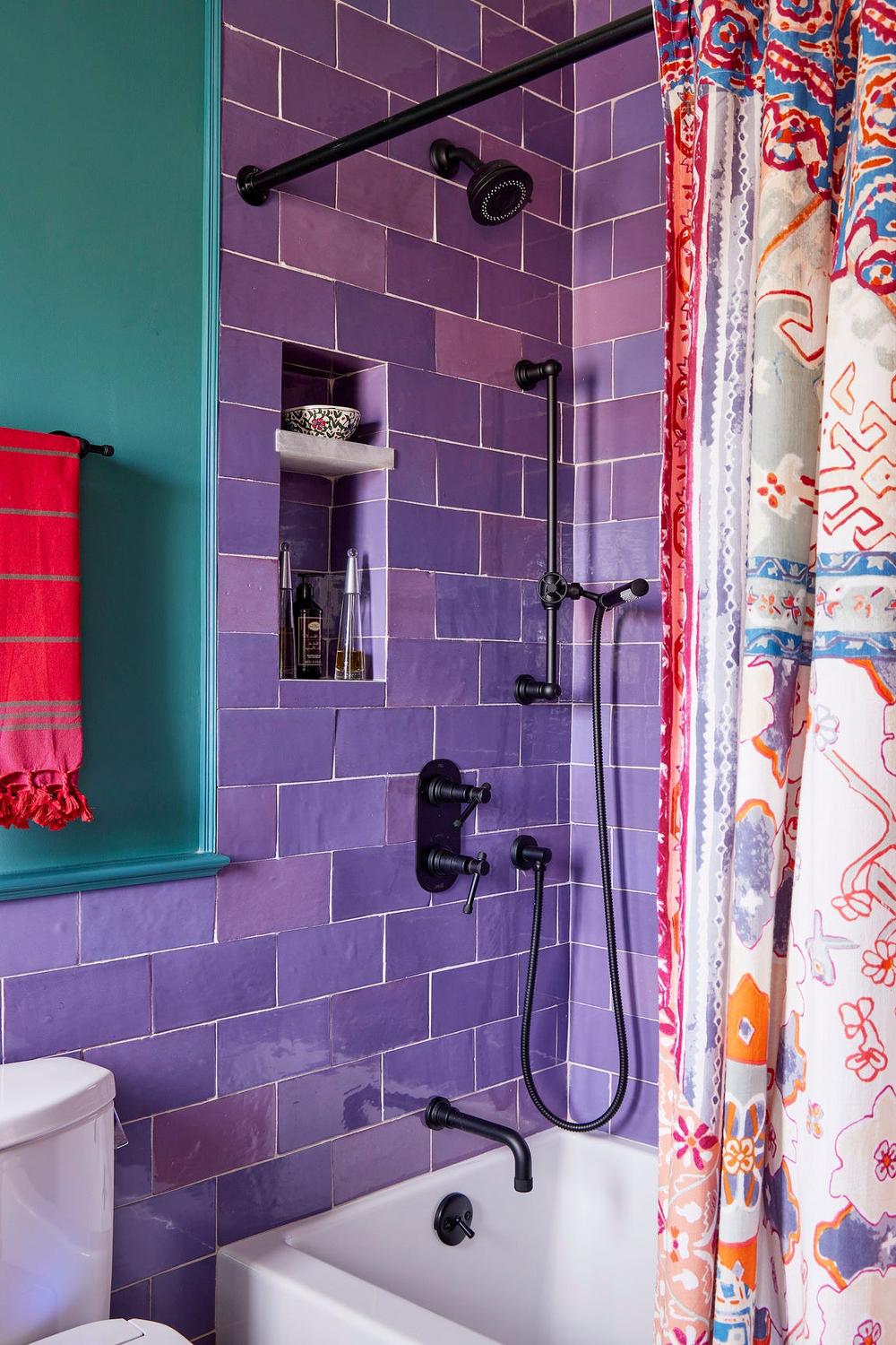 Contemporary bathroom with vibrant shower area and recessed shelves
