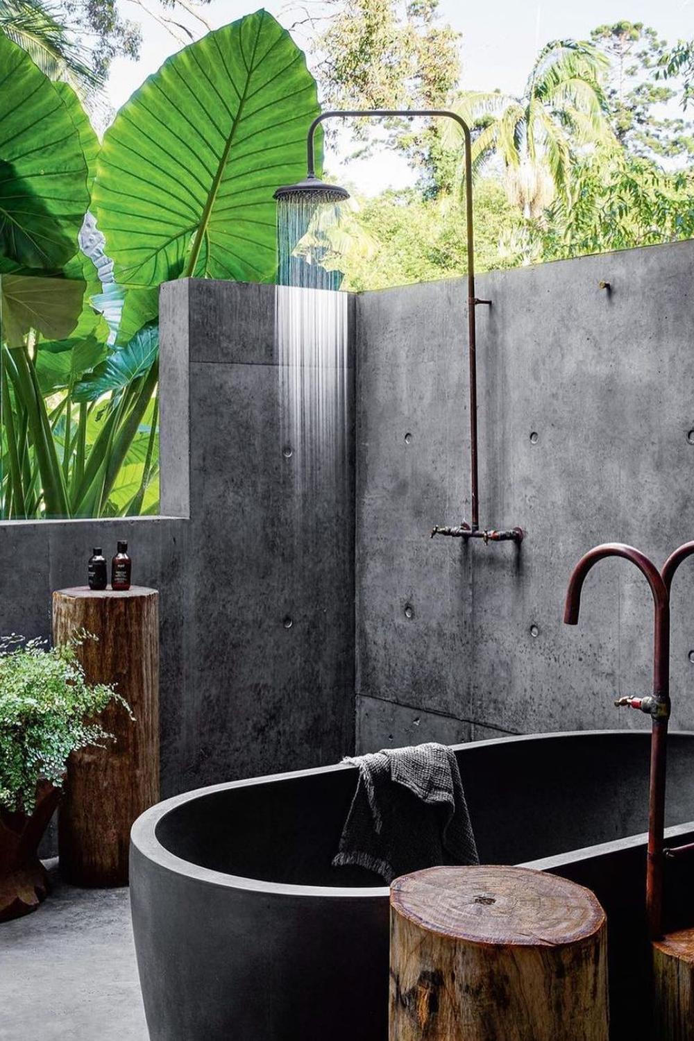 Modern rainforest bathroom featuring a stylish bathtub and plants