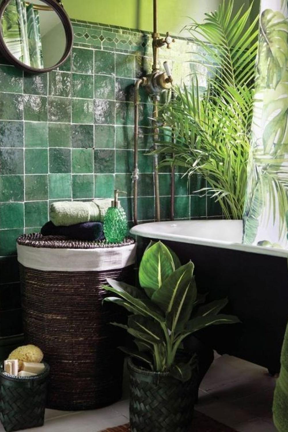 Bathroom with lush green walls and clawfoot bathtub