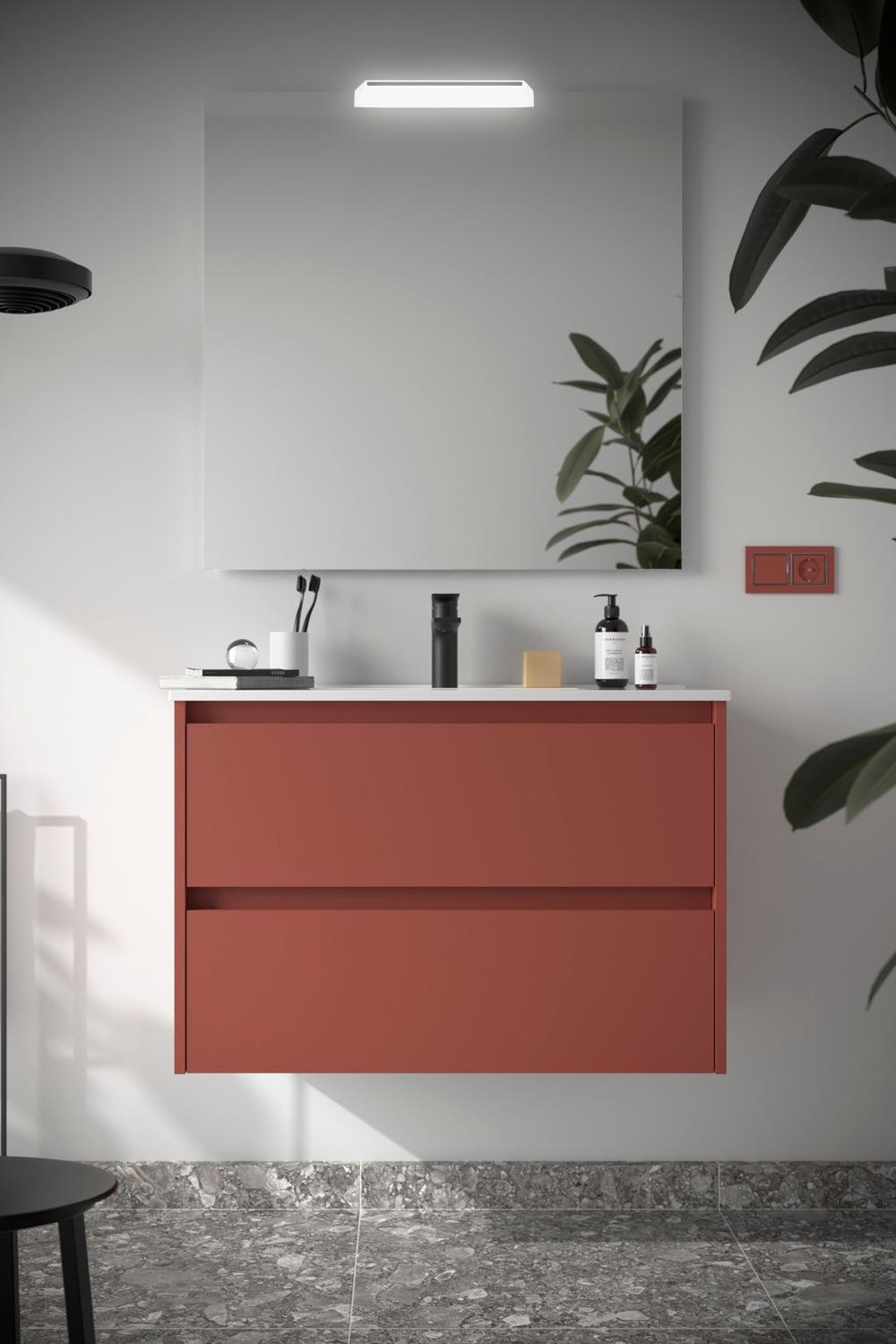 A sleek-mounted red vanity unit with a light countertop in a modern setup.