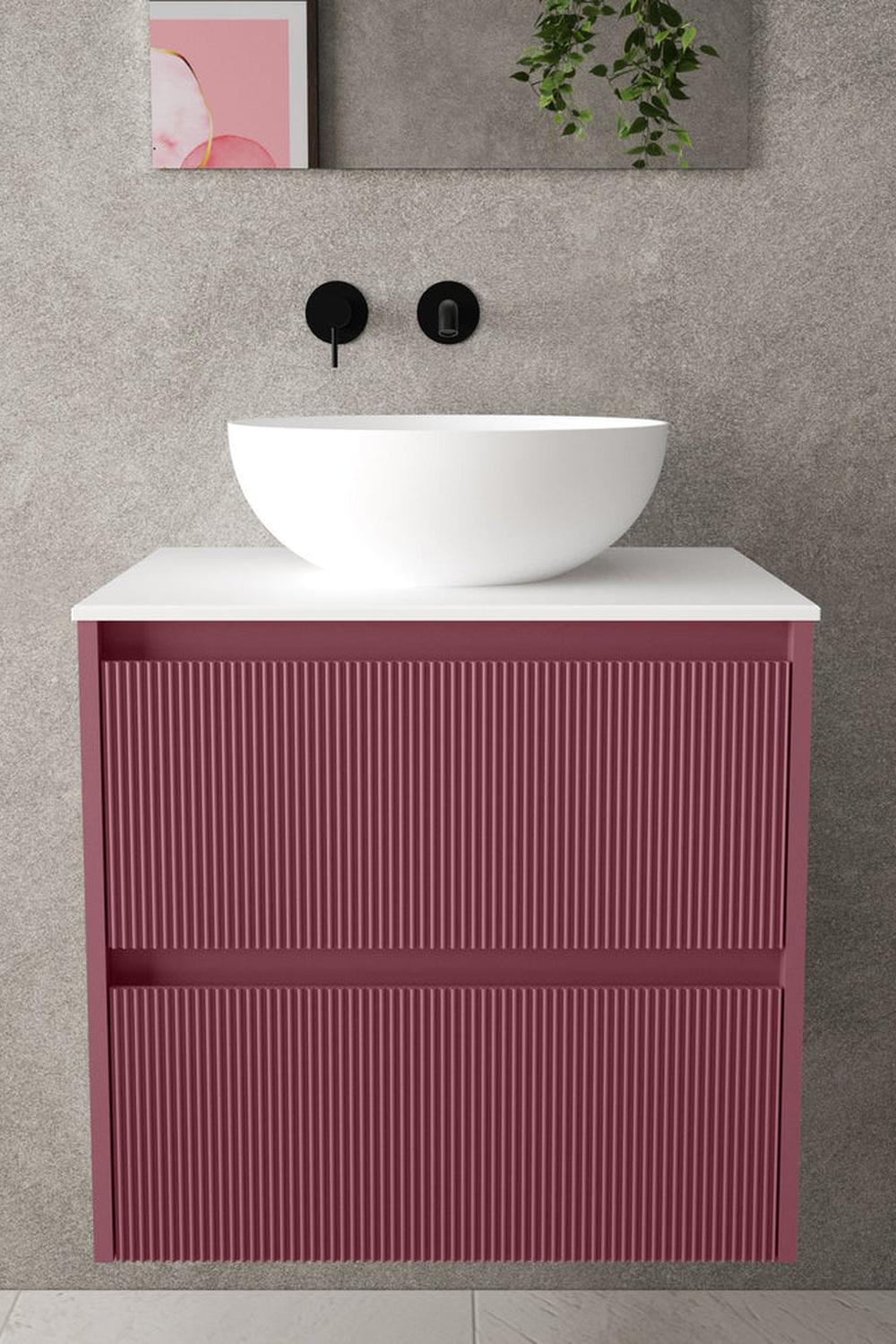A bold red vanity with a textured design contrasted by a white vessel sink.