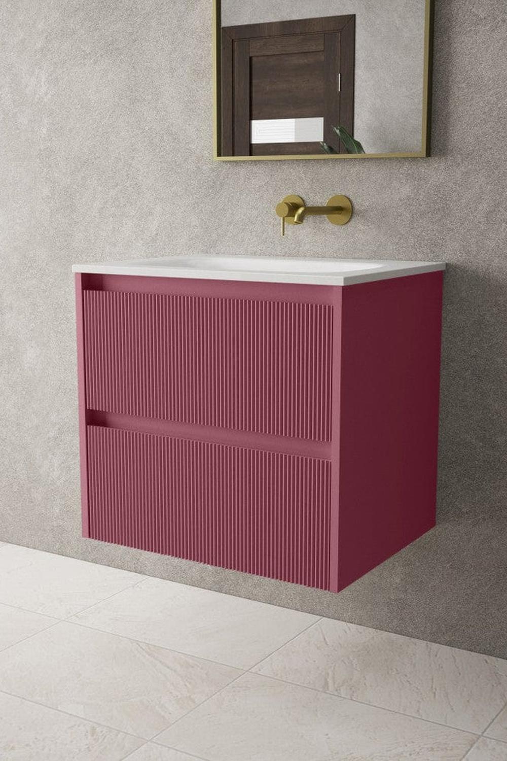 A contemporary red vanity featuring horizontal grooves, contrasted with a white countertop and gold accents.