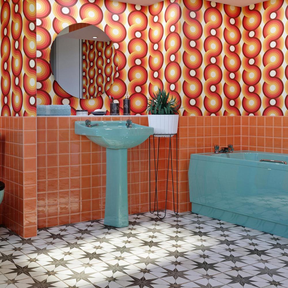 Vibrant retro bathroom showcasing curvy graphic wallpaper and turquoise pedestal sink.