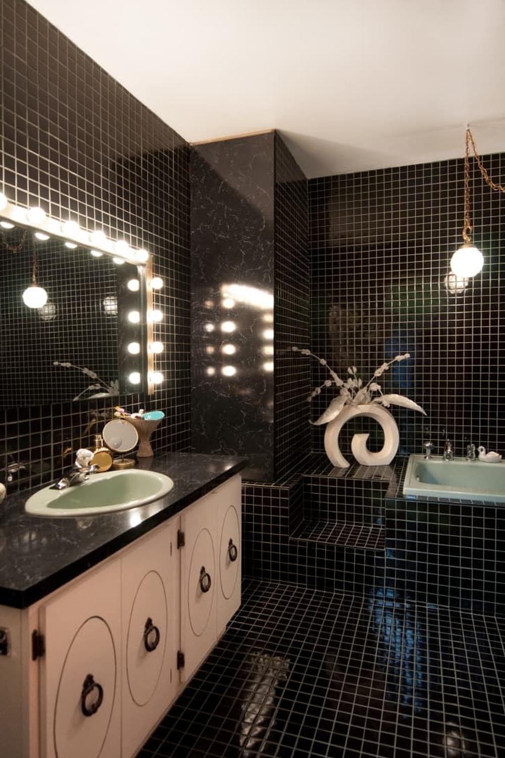 Retro bathroom featuring bold black and white checkered tiles and green accents.