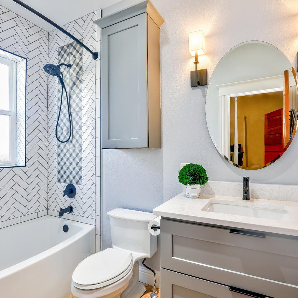 Chic bathroom showcasing light color scheme with soft grays and whites.