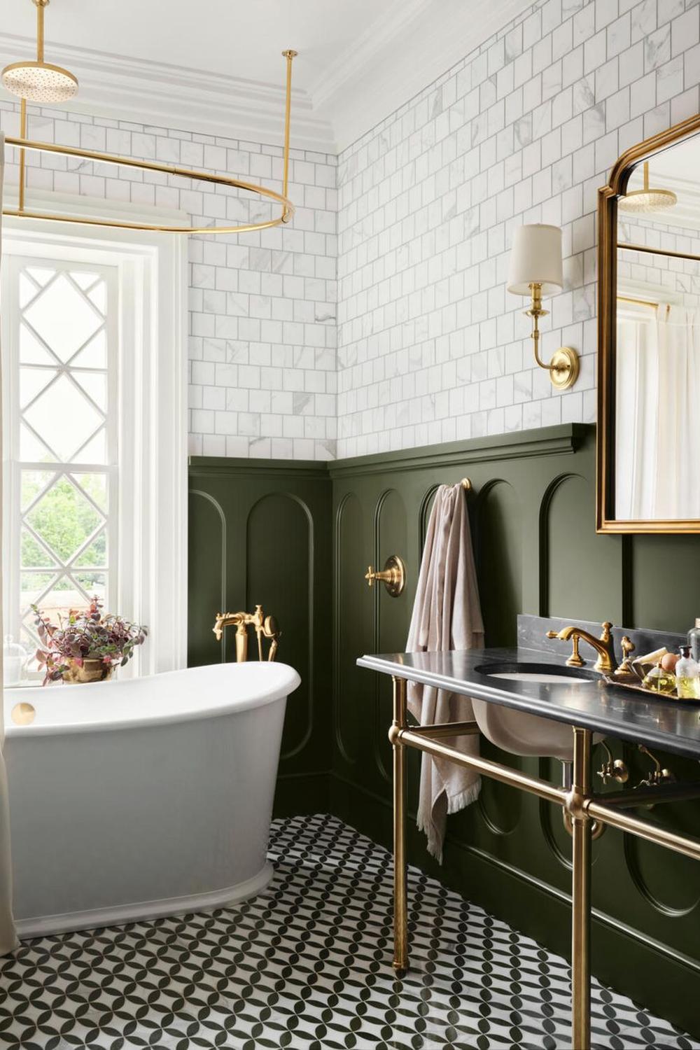 Stylishly designed retro bathroom featuring rich green wainscoting and decorative black-and-white flooring.