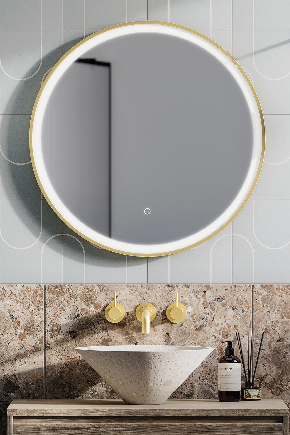 Large round mirror with integrated lighting above a unique bowl-shaped sink.