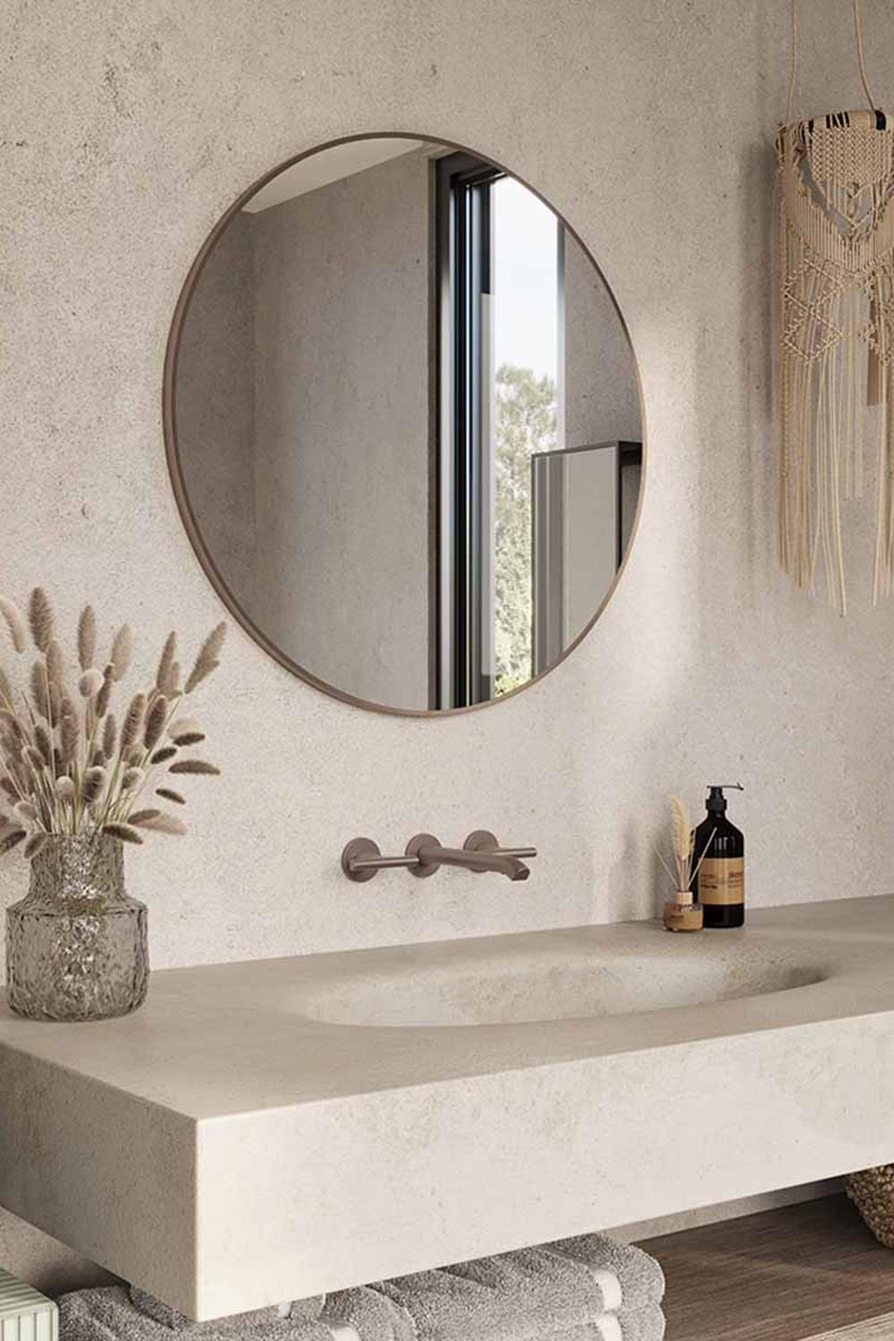 Round mirror accented by a textured wall and sleek sink design.