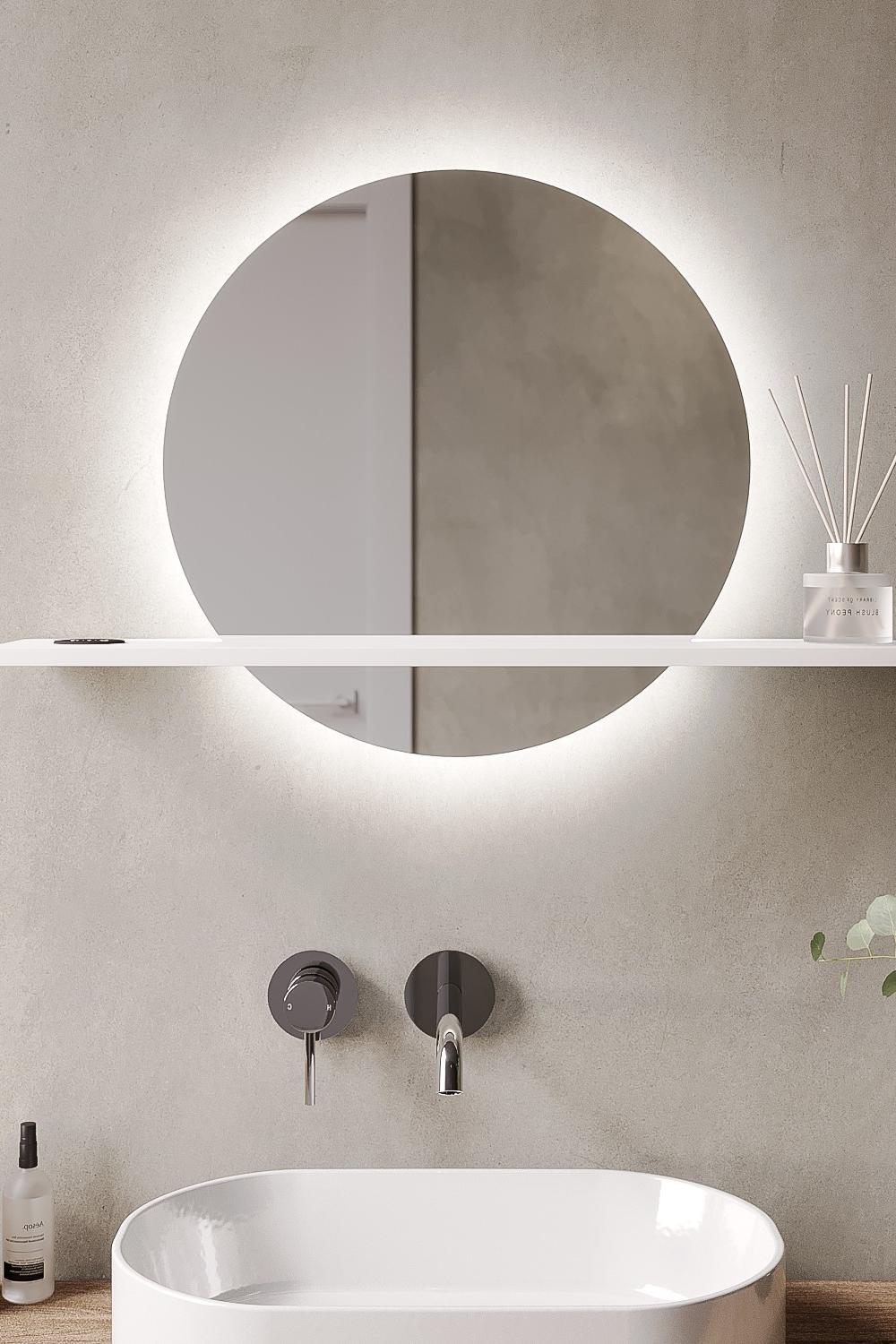 Minimalist round mirror featuring wall-mounted faucets in a stylish bathroom.