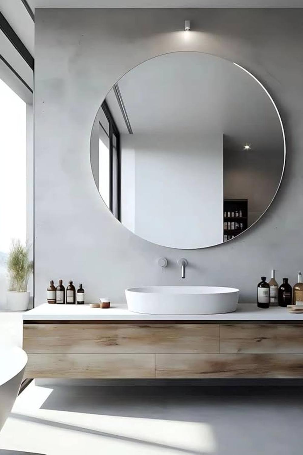 Large round mirror emphasizing modern simplicity in a contemporary bathroom setup.