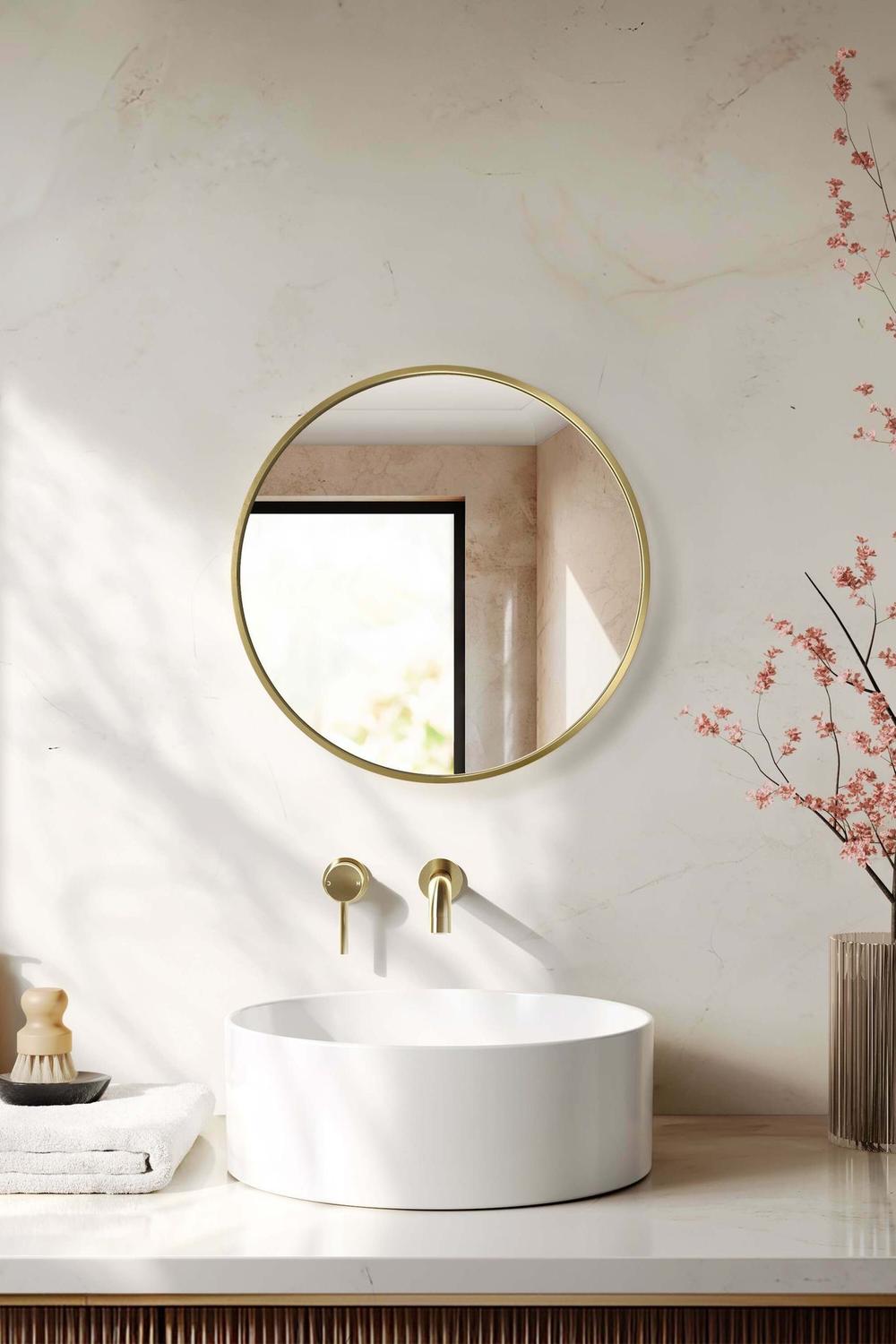 Round mirror highlighting warm natural elements in a well-designed bathroom ambiance.