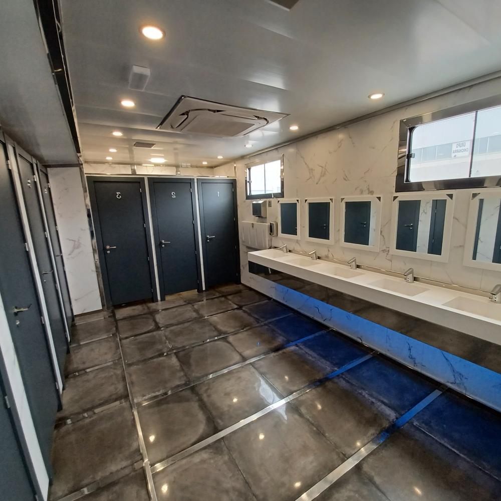 Modern restroom with sophisticated design featuring polished tiles and a marble pattern