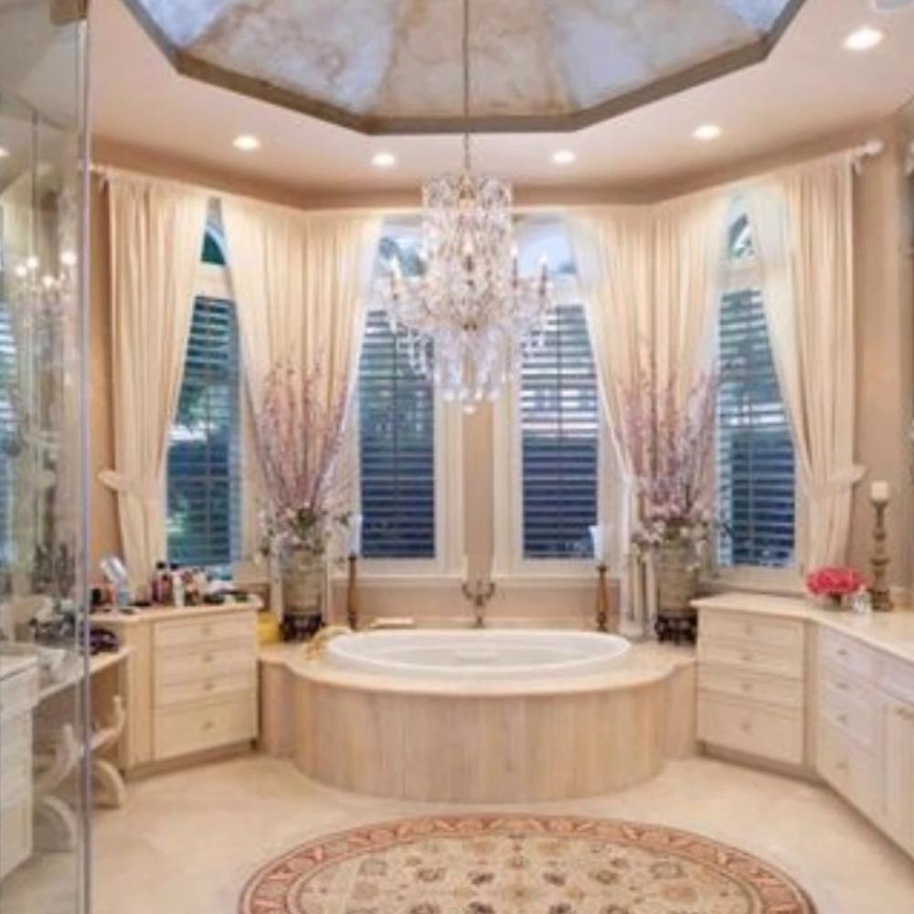 Elegant bathroom with a spa-like freestanding bathtub and gorgeous chandelier