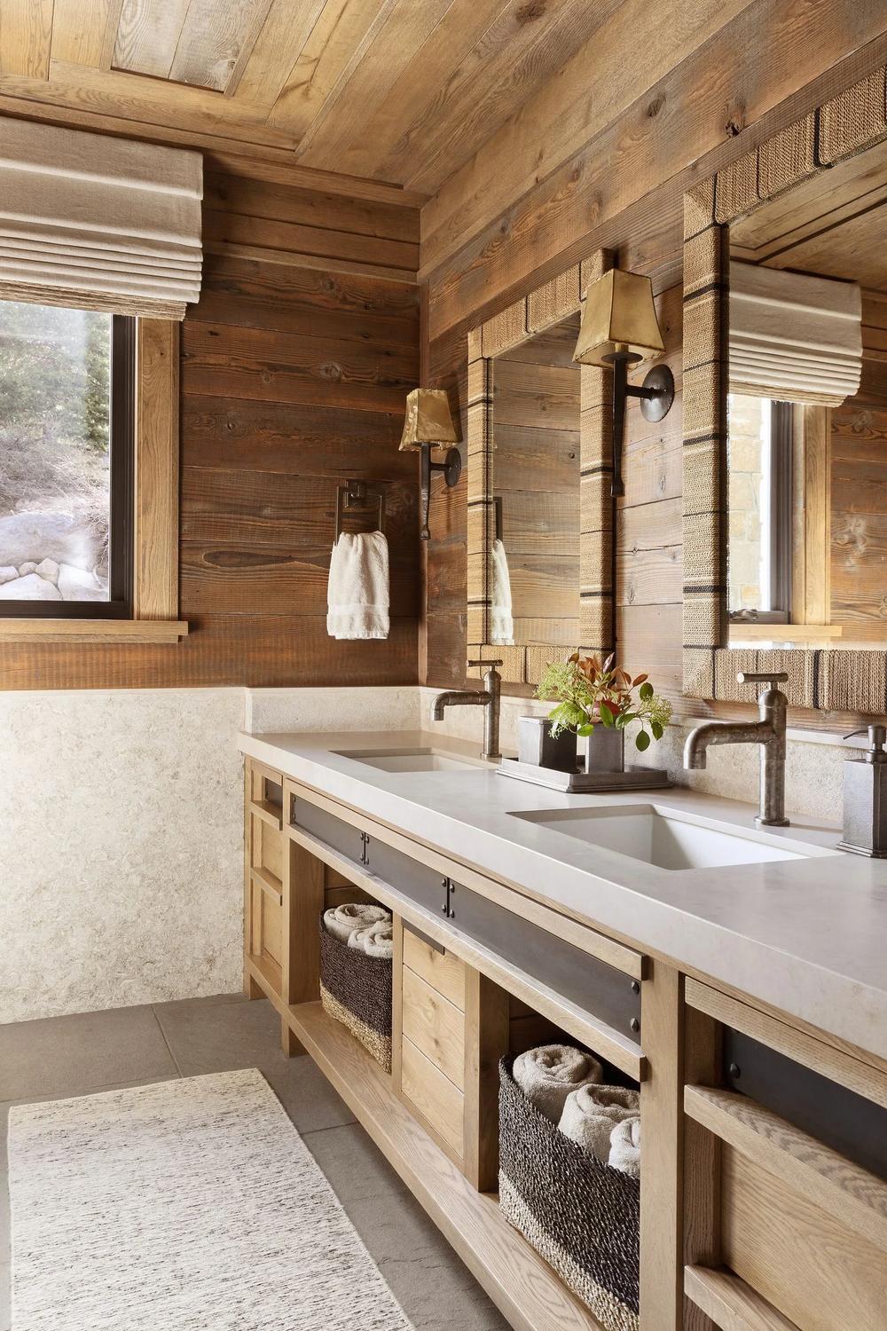 Rustic bathroom with warm wood paneling and double vanity with unique storage solutions.