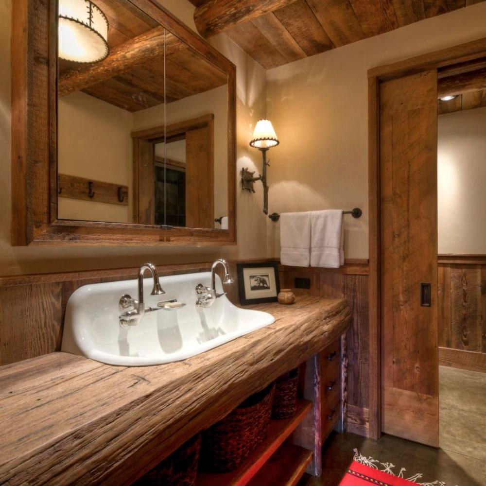 Rustic bathroom with reclaimed wood vanity and practical storage options.