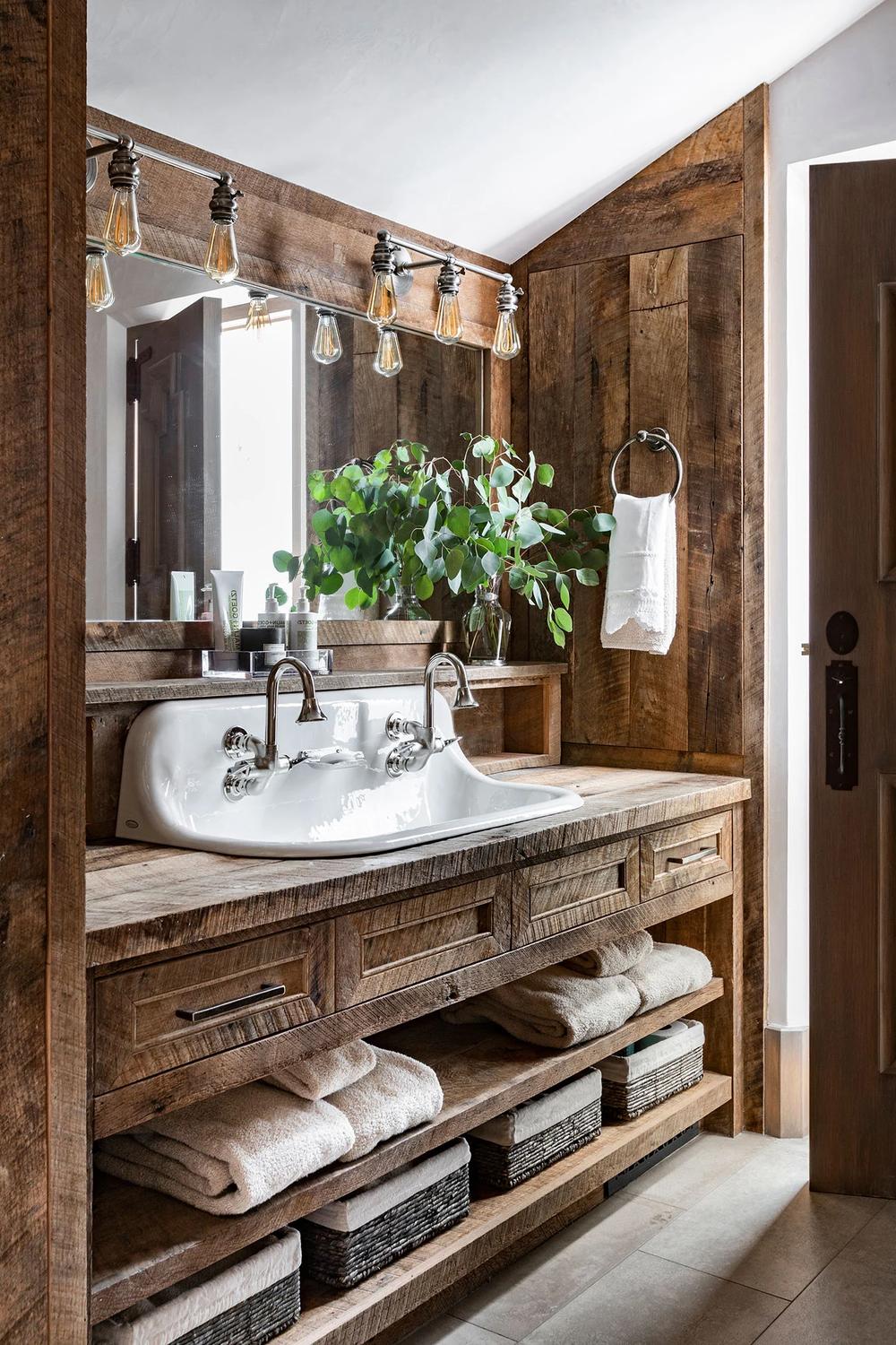 Spacious rustic bathroom with freestanding white bathtub and natural wooden accents.
