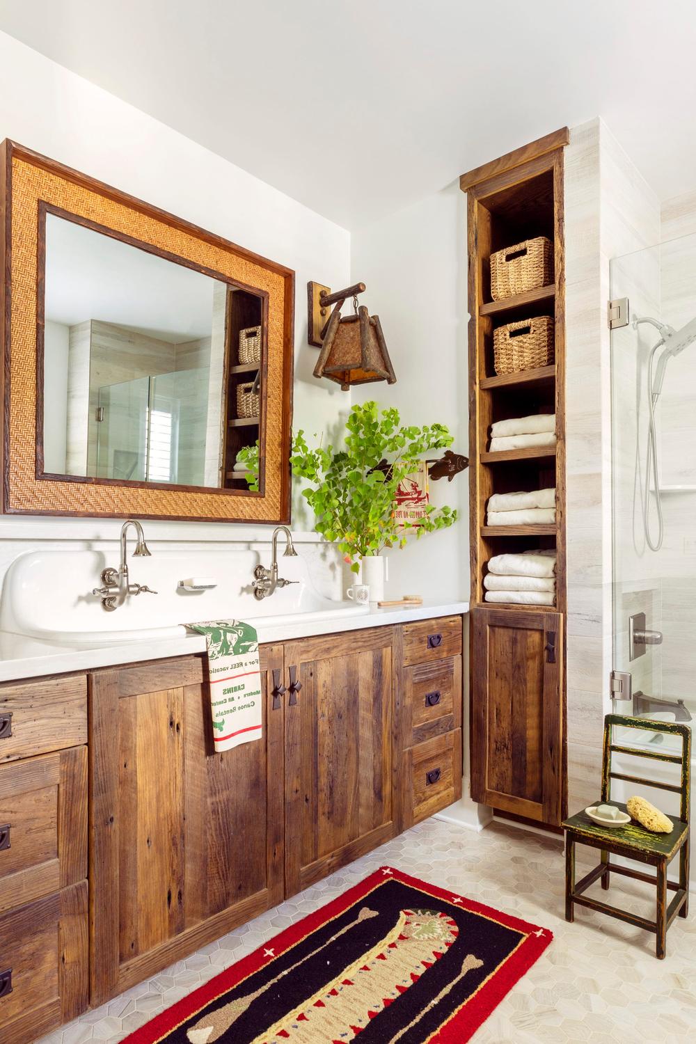 Rustic farmhouse bathroom featuring a double sink vanity with reclaimed wood and vintage-style faucets.
