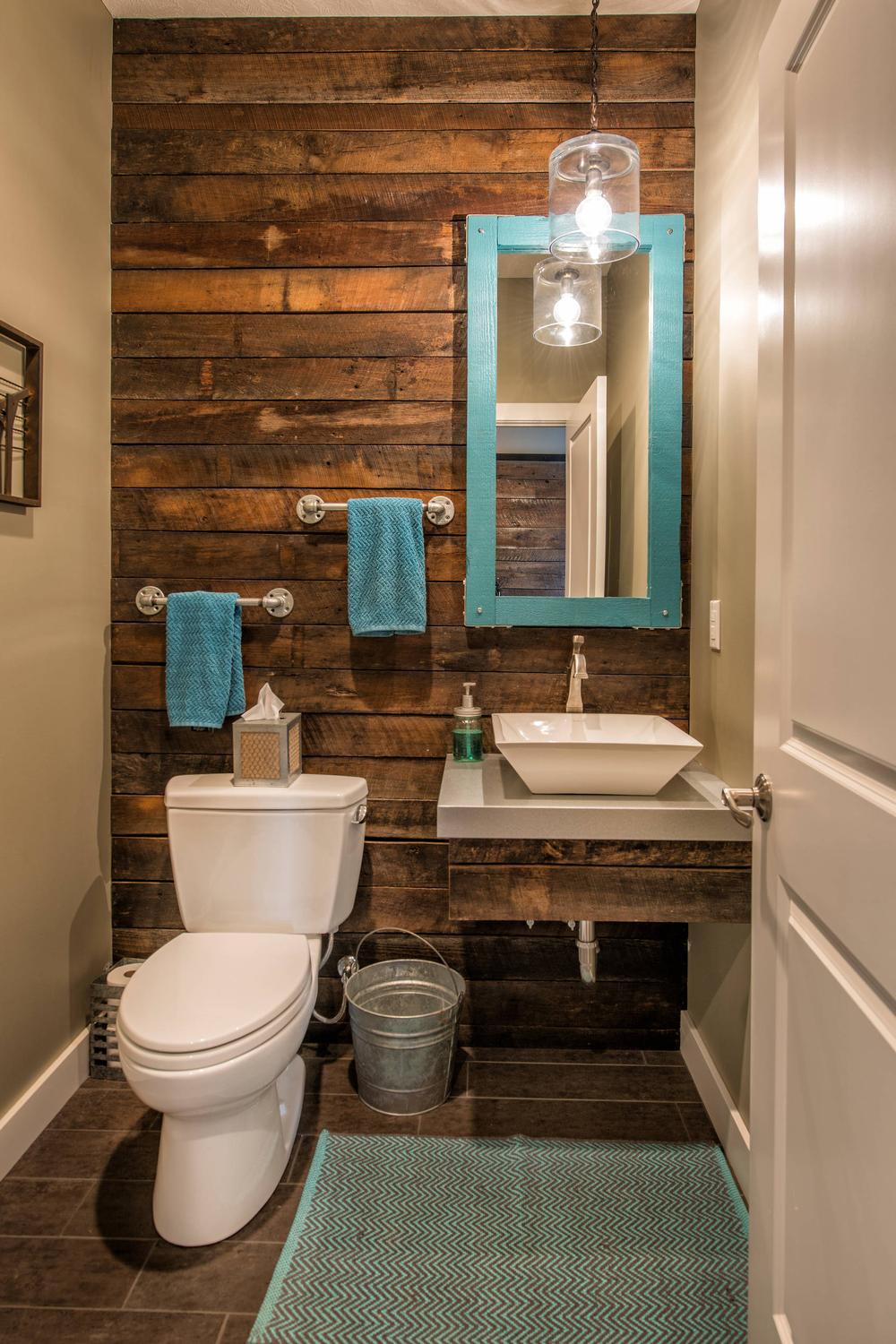 Charming rustic industrial bathroom showcasing vintage wood panels and modern design elements.