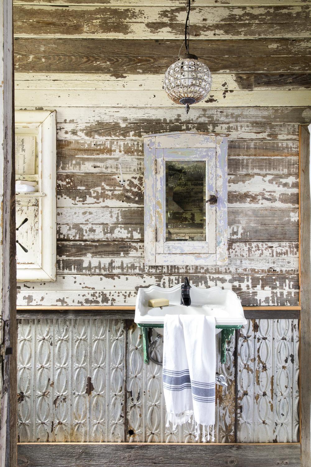 Charming rustic industrial bathroom with elegant metal accents.