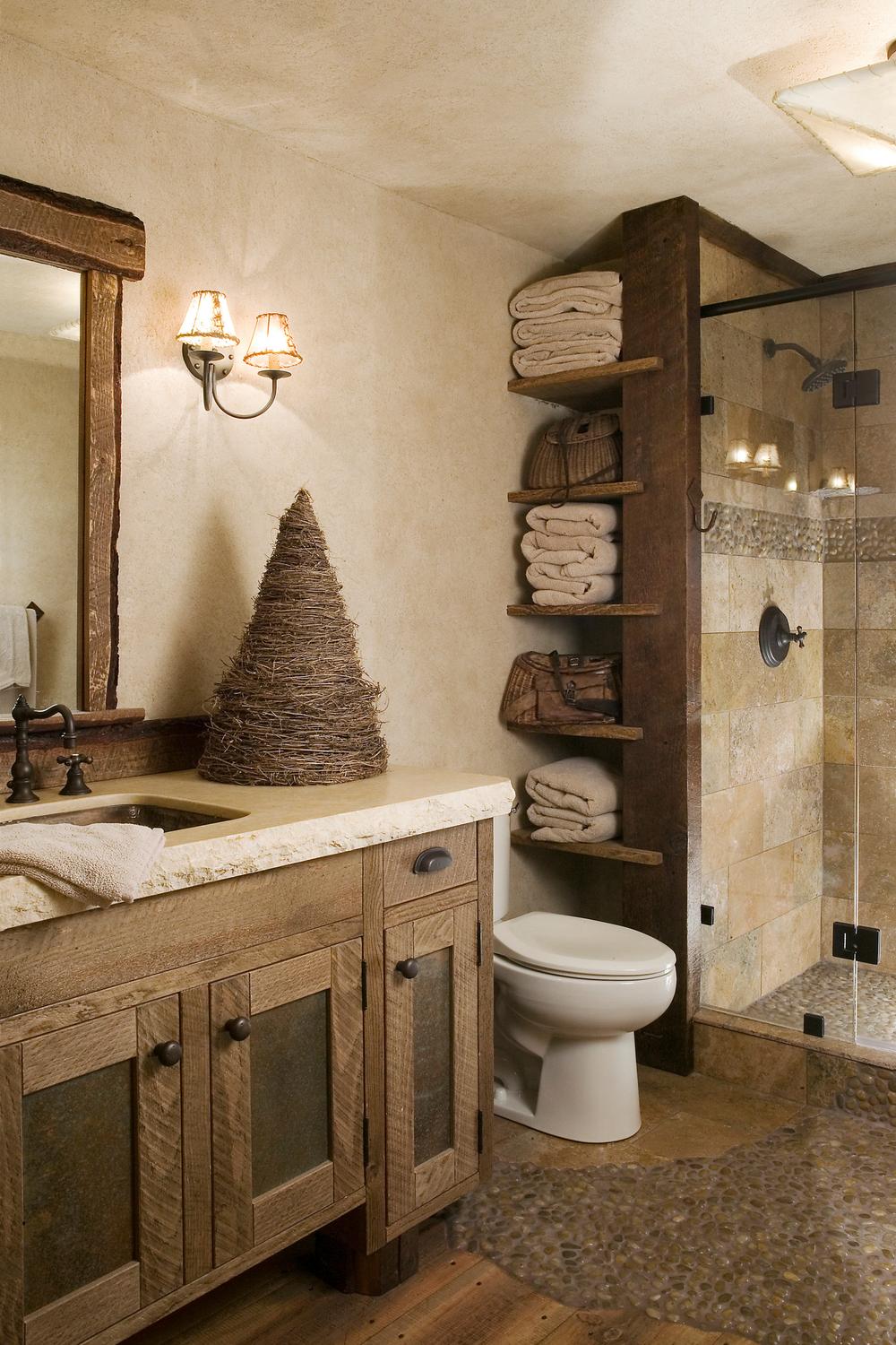 A rustic bathroom featuring a unique wooden vanity with dual sinks and a warm ambiance.