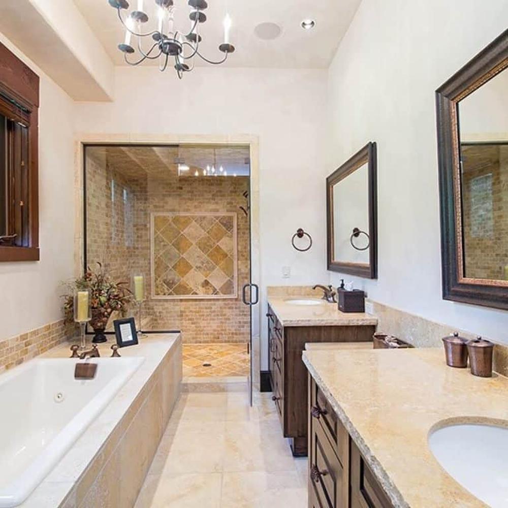 A rustic bathroom featuring a view of nature with earthy tones and elegant features.