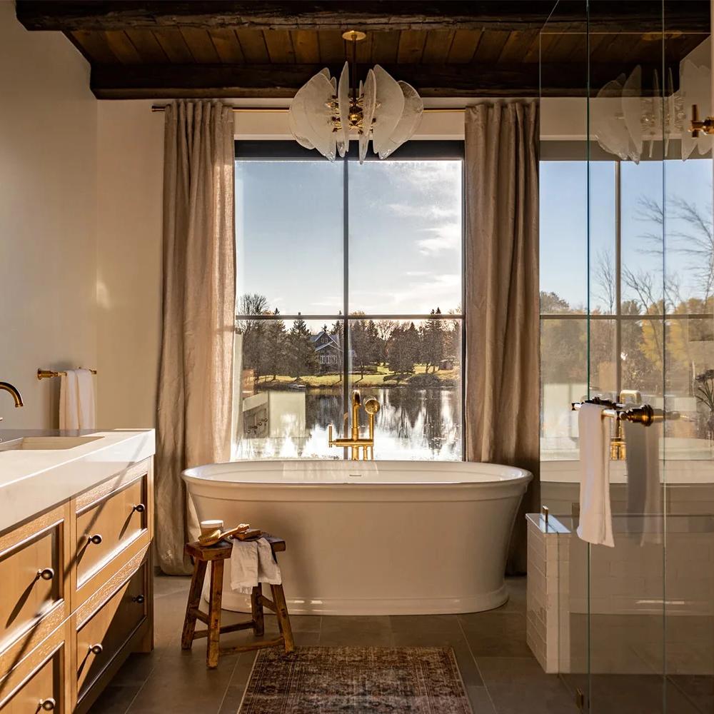 A rustic bathroom featuring a serene ambiance and nature views.