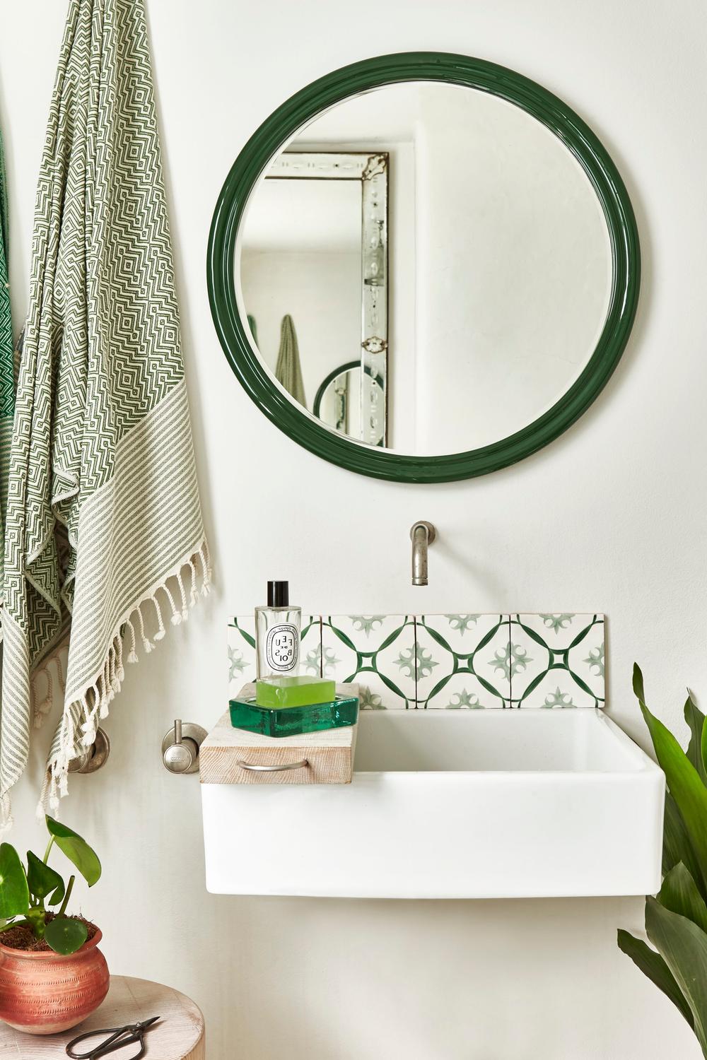 bathroom featuring round mirrors with sage color scheme