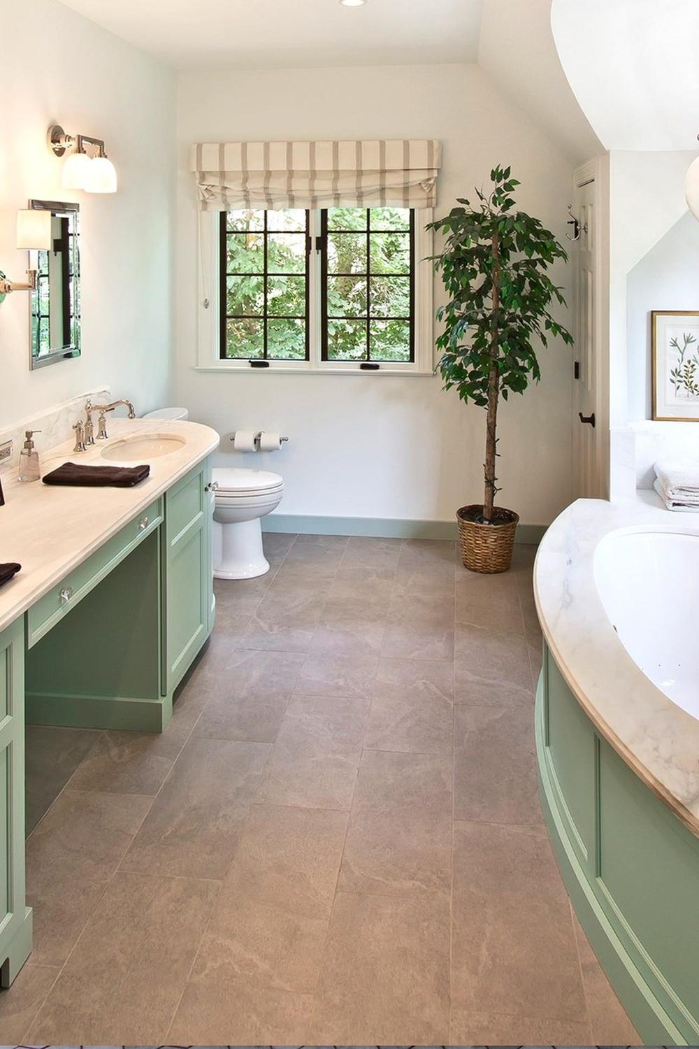 bathroom featuring soft white accents and sage green cabinetry