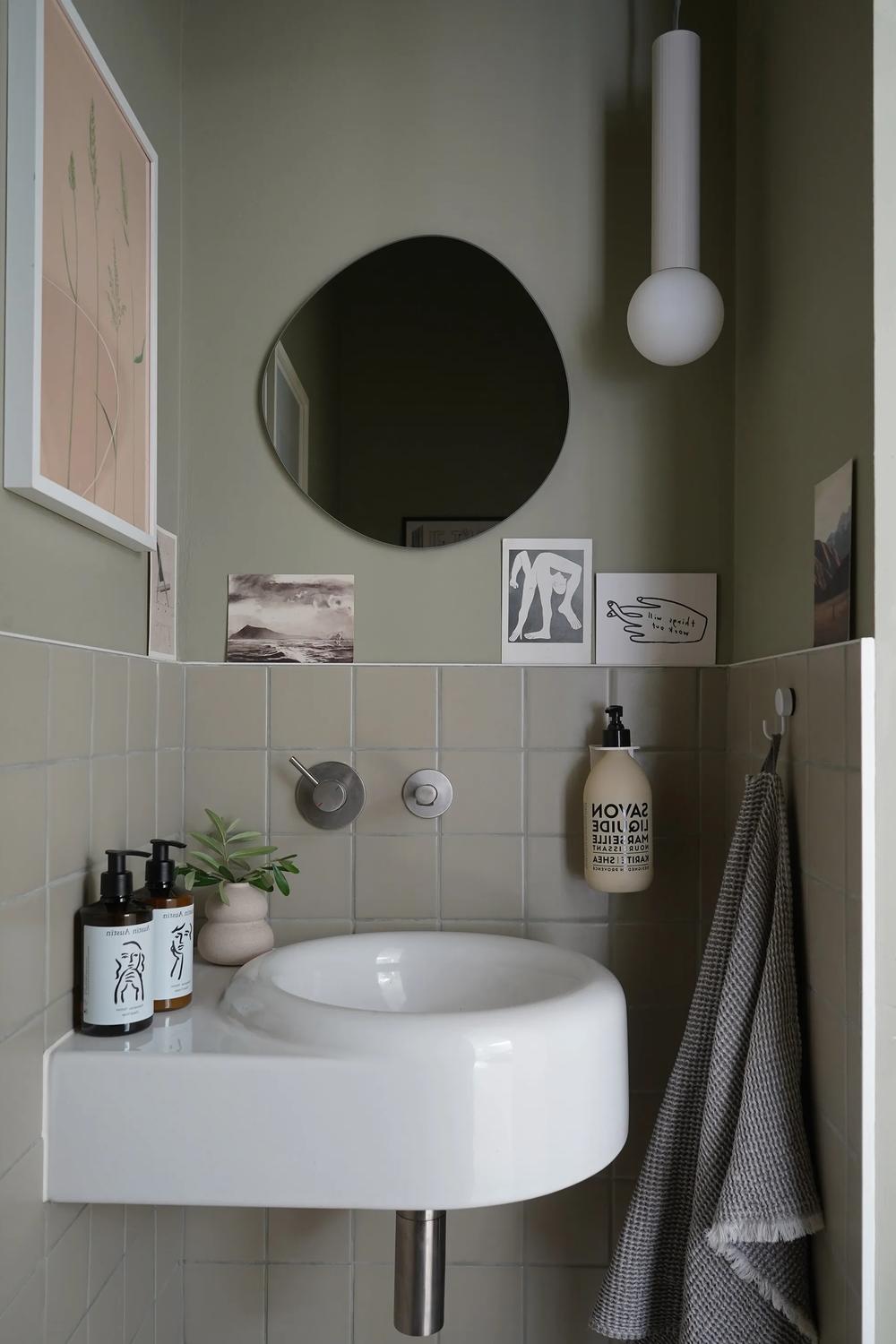 bathroom featuring bold lighting with sage accents