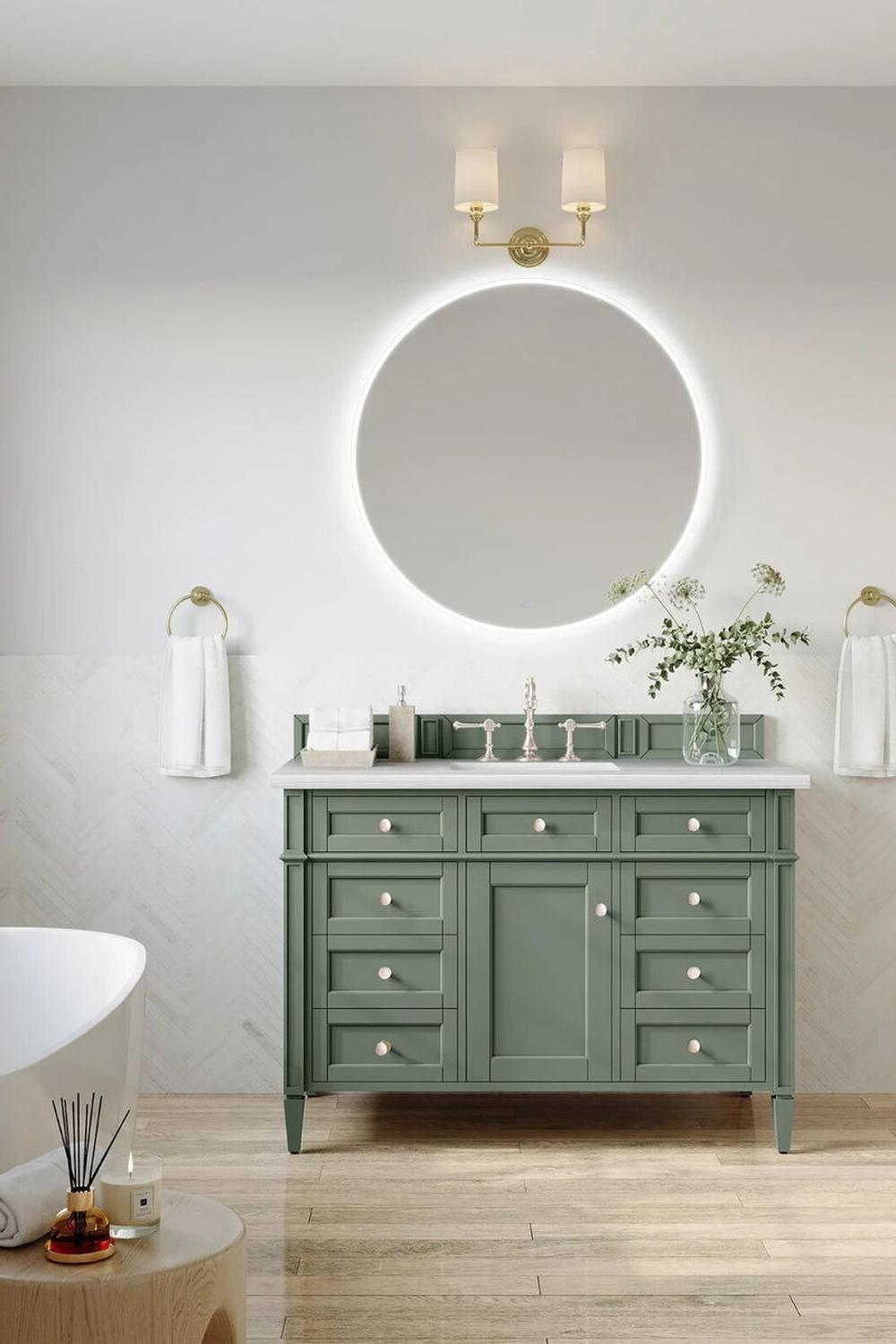 Inviting sage green vanity adorned with two undermount sinks and a welcoming ambiance.