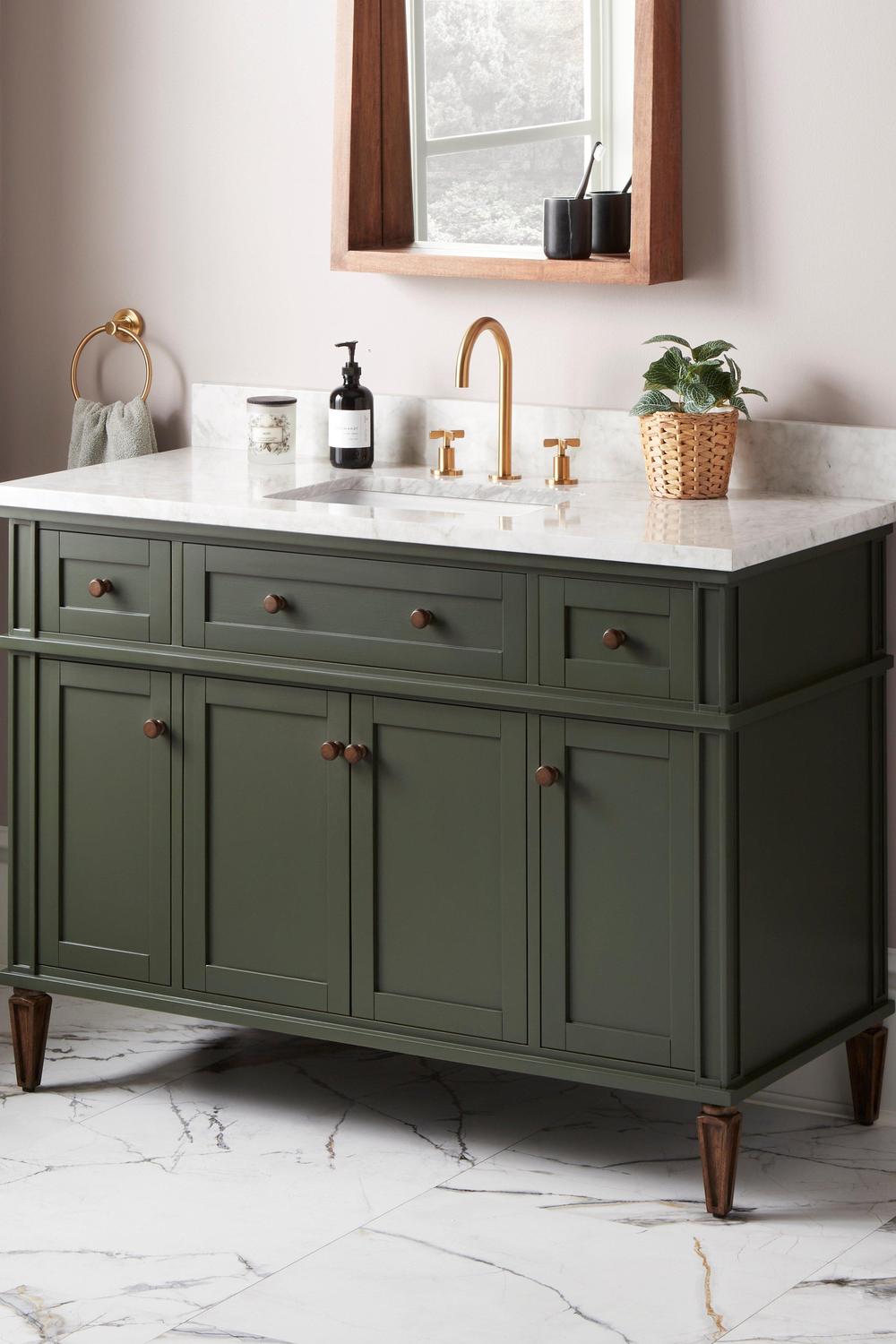 Bold sage green vanity achieving modern flair with geometric designs and chic sink fixtures.