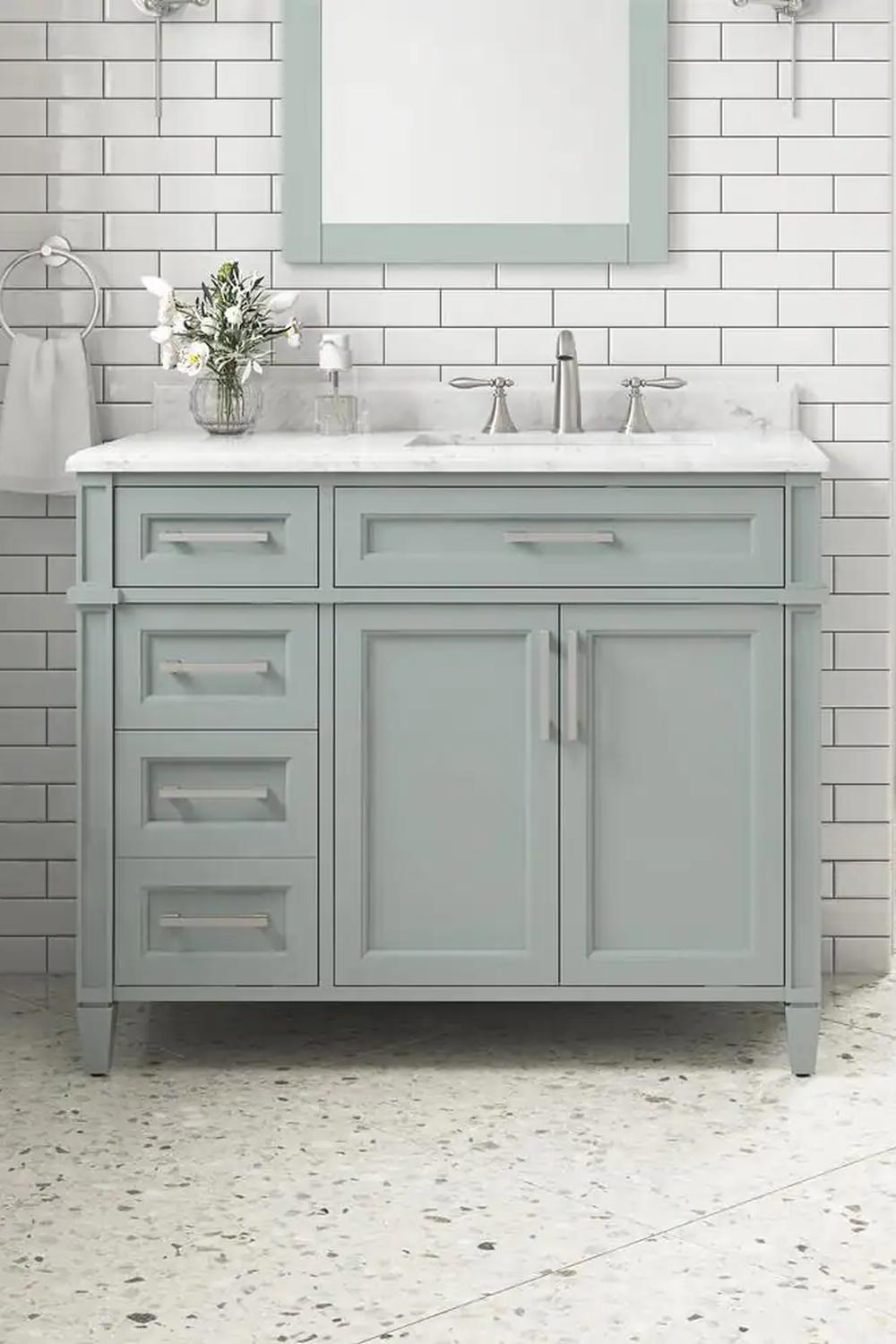 Sleek sage green vanity with dual functionality for an elegant and fresh bathroom setting.