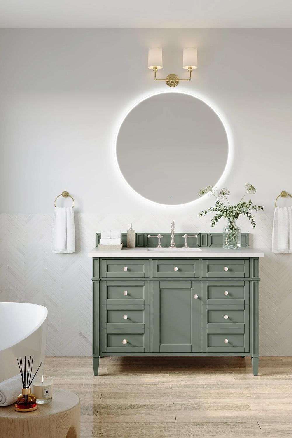 Charming sage green bathroom vanity surrounded by fresh greenery and modern accents.