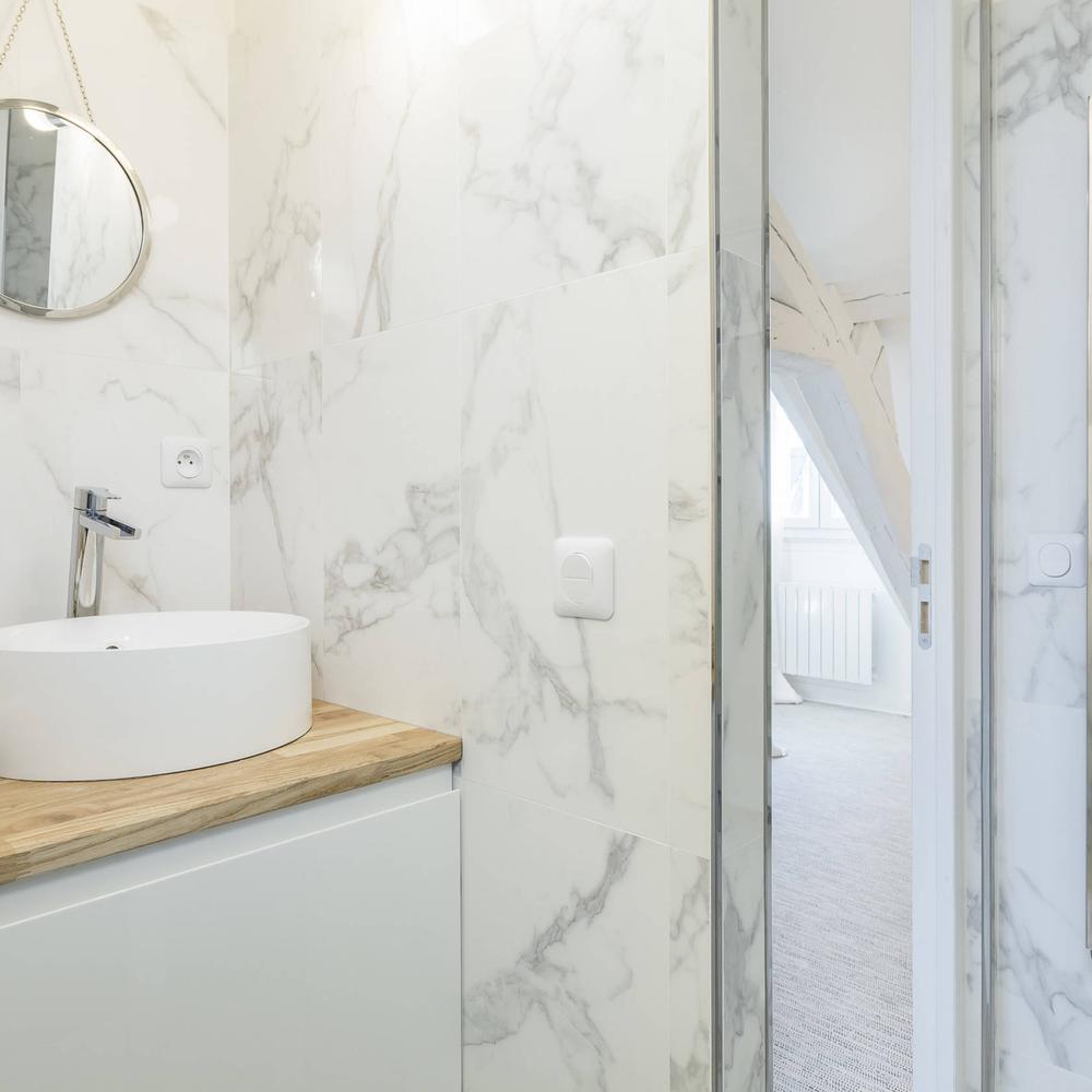 Baño escandinavo compacto con mármol y detalles naturales